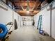 Spacious unfinished basement featuring laundry area, ladder, and concrete floor at 10029 Freestone Ln, Port Richey, FL 34668