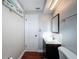 Bright bathroom featuring a toilet, and dark vanity with framed mirror at 10029 Freestone Ln, Port Richey, FL 34668