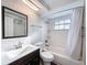 Bathroom with a modern vanity, toilet, and a shower with white tiled walls at 10029 Freestone Ln, Port Richey, FL 34668