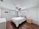 Cozy bedroom features ceiling fan, windows for natural light, and wood-look flooring at 10029 Freestone Ln, Port Richey, FL 34668