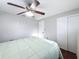 Bright bedroom with hardwood floors, ceiling fan, and closet at 10029 Freestone Ln, Port Richey, FL 34668
