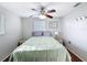 Bedroom with a ceiling fan, hardwood floors, and windows with blinds at 10029 Freestone Ln, Port Richey, FL 34668