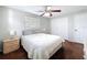 Bright bedroom features ceiling fan, window for natural light, and wood-look flooring at 10029 Freestone Ln, Port Richey, FL 34668