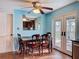 Cozy dining area with a ceiling fan, seating, and sliding glass doors to the backyard at 10029 Freestone Ln, Port Richey, FL 34668