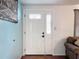 Elegant front door with decorative glass inserts, paired with stylish hardware, offers a warm welcome at 10029 Freestone Ln, Port Richey, FL 34668