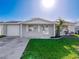 Charming home with a well-manicured front yard, featuring lush green grass and a tidy, inviting facade at 10029 Freestone Ln, Port Richey, FL 34668