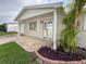 Charming single-story home featuring brickwork, well-maintained landscaping, and a welcoming covered entryway at 10029 Freestone Ln, Port Richey, FL 34668