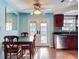 Kitchen and dining area with a view of the sink, cabinets, and double glass doors at 10029 Freestone Ln, Port Richey, FL 34668