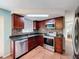 Updated kitchen with stainless steel appliances, granite countertops, tile backsplash, and skylight at 10029 Freestone Ln, Port Richey, FL 34668