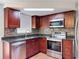 Updated kitchen with stainless steel appliances, granite countertops, and tile backsplash at 10029 Freestone Ln, Port Richey, FL 34668