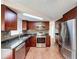 Updated kitchen with stainless steel appliances, granite countertops, tile backsplash, and skylight at 10029 Freestone Ln, Port Richey, FL 34668