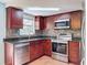 Updated kitchen with stainless steel appliances, granite countertops, and tile backsplash at 10029 Freestone Ln, Port Richey, FL 34668