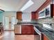 Updated kitchen features granite countertops, stainless steel appliances, and wood cabinets at 10029 Freestone Ln, Port Richey, FL 34668