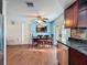 Eat-in kitchen features stainless steel appliances, wood-look tile flooring, and light blue accent wall at 10029 Freestone Ln, Port Richey, FL 34668
