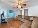 Open-concept living area with stylish wood floors, comfortable seating, and ample natural light at 10029 Freestone Ln, Port Richey, FL 34668