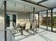Covered patio with dining set, perfect for outdoor entertaining by the pool at 10029 Freestone Ln, Port Richey, FL 34668