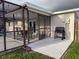 Outdoor living space featuring a dining table, grill, and screened-in patio with access to a sparkling pool at 10029 Freestone Ln, Port Richey, FL 34668