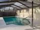 Sparkling pool with railings and a screened enclosure for year-round enjoyment at 10029 Freestone Ln, Port Richey, FL 34668