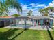 Relax in your screened-in pool with beautiful backyard landscaping and plenty of seating for enjoying the outdoors at 10029 Freestone Ln, Port Richey, FL 34668