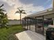 Outdoor living with a dining table, grill, and a screened enclosure surrounding the beautiful pool area at 10029 Freestone Ln, Port Richey, FL 34668
