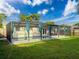 Enjoy outdoor Florida living in your screened in pool with patio table and chairs at 10029 Freestone Ln, Port Richey, FL 34668