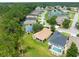 Beautiful aerial view featuring houses with pools surrounded by lush green spaces and a serene pond at 10097 Holly Berry Dr, Weeki Wachee, FL 34613