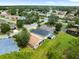 Neighborhood aerial view showing well-maintained homes, green spaces, and a tranquil pond at 10097 Holly Berry Dr, Weeki Wachee, FL 34613