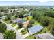 Beautiful aerial view of the property with a tranquil pond, mature trees, and manicured lawns at 10097 Holly Berry Dr, Weeki Wachee, FL 34613