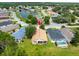 Neighborhood aerial view showcasing beautiful homes, mature landscaping, and a peaceful pond at 10097 Holly Berry Dr, Weeki Wachee, FL 34613