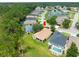 Picturesque aerial shot captures a beautiful home nestled among lush greenery and serene pond views at 10097 Holly Berry Dr, Weeki Wachee, FL 34613