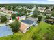 Property aerial view with a mix of lush greenery, a serene pond, and houses, offering a desirable neighborhood setting at 10097 Holly Berry Dr, Weeki Wachee, FL 34613