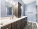Beautiful bathroom with double sinks, dark wood cabinets, and modern fixtures at 10097 Holly Berry Dr, Weeki Wachee, FL 34613