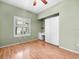 Inviting bedroom featuring hardwood floors, a built-in desk and a bright window at 10097 Holly Berry Dr, Weeki Wachee, FL 34613