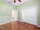 Comfortable bedroom features a ceiling fan, closet and hardwood floors at 10097 Holly Berry Dr, Weeki Wachee, FL 34613
