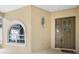 Covered entryway showcasing a stylish front door and elegant exterior lighting at 10097 Holly Berry Dr, Weeki Wachee, FL 34613