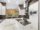 Elegant kitchen with black granite counters, center island, stainless appliances, and white cabinets at 10097 Holly Berry Dr, Weeki Wachee, FL 34613