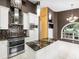 Stylish kitchen features black granite countertops, stainless steel appliances and white cabinets at 10097 Holly Berry Dr, Weeki Wachee, FL 34613
