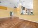 Inviting living area showcasing hardwood floors and an open layout to the kitchen at 10097 Holly Berry Dr, Weeki Wachee, FL 34613