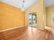 Spacious living room with hardwood floors and a view of the screened-in porch at 10097 Holly Berry Dr, Weeki Wachee, FL 34613