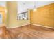 Open living area with hardwood floors, natural light, and views of the kitchen at 10097 Holly Berry Dr, Weeki Wachee, FL 34613
