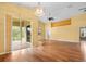 Bright living room with hardwood floors, large sliding glass doors, and high ceilings at 10097 Holly Berry Dr, Weeki Wachee, FL 34613
