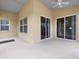 Large patio perfect for outdoor entertaining with windows and sliding glass doors at 10097 Holly Berry Dr, Weeki Wachee, FL 34613