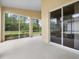 Relaxing screened-in patio with sliding glass doors offers natural light and outdoor views at 10097 Holly Berry Dr, Weeki Wachee, FL 34613
