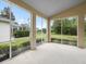 Screened patio with peaceful backyard views of green grass, pool, and trees at 10097 Holly Berry Dr, Weeki Wachee, FL 34613