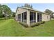 Inviting screened-in porch provides a cozy outdoor living space, perfect for enjoying the backyard view at 10097 Holly Berry Dr, Weeki Wachee, FL 34613