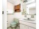 Classic bathroom features a light green toilet and sink with tiled walls and window at 10123 Oak Hill Dr, Port Richey, FL 34668