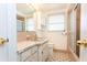 Bright bathroom with pink tiling, updated vanity, mirror, and walk-in shower at 10123 Oak Hill Dr, Port Richey, FL 34668