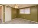 Bedroom with standard closet, two windows, olive-green walls, and ceiling fan at 10123 Oak Hill Dr, Port Richey, FL 34668