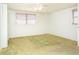 Bedroom with neutral colored walls and flooring, with two windows providing natural light at 10123 Oak Hill Dr, Port Richey, FL 34668