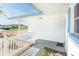 Inviting entrance with blue shutters, white railings, and well-maintained landscaping at 10123 Oak Hill Dr, Port Richey, FL 34668